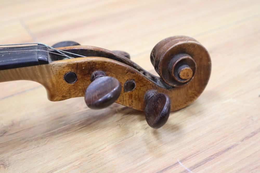 A cased violin with two bows. Violin bears the label Carl Willhelm Claesel, circa late 18th century/early 19th century, 35.5cm back in